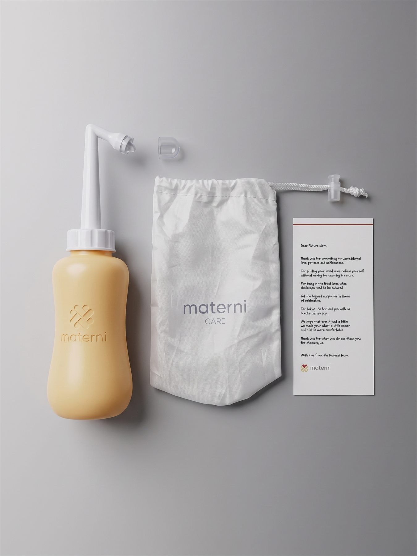 Peri bottle, travel pouch, and thank-you note flat lay